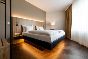 Postel nebo postele na pokoji v ubytování GINN City & Lounge Yorck Berlin