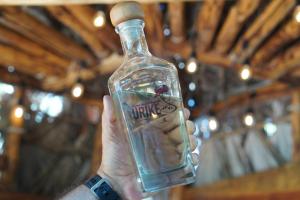 a person holding a bottle with a cork on it at Hotel Villa de Urike in Urique