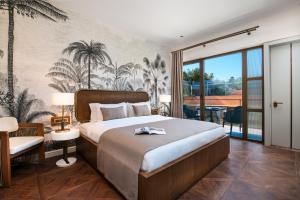 a bedroom with a large bed and a balcony at Genesis Hotel&Spa Alaçatı in Alaçatı +72 photos