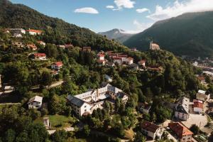 an aerial view of a village in the mountains at Hostel Idrija in Idrija