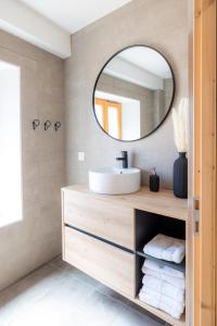 a bathroom with a sink and a mirror at Joli T3 en Duplex avec terrasse #6 in Embrun
