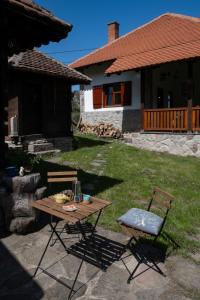 a picnic table and chairs in the yard of a house at Kuca pod Rudnikom in Trudelj