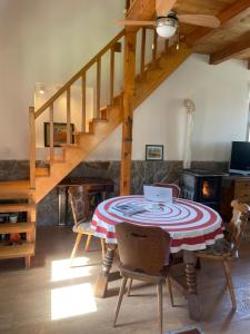a dining room with a table with a laptop on it at Kuca pod Rudnikom in Trudelj
