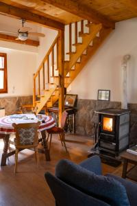a living room with a fireplace and a stove at Kuca pod Rudnikom in Trudelj