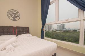 a bedroom with a bed and a large window at Mutiara Ville Cyberjaya by Idealhub in Cyberjaya +24 photos