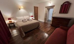 A bed or beds in a room at Les Distinguées - Manoir de Bessodes