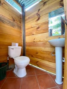 a bathroom with a toilet and a sink at Tipis Ya' in San Pedro La Laguna