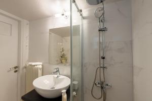 a bathroom with a sink and a shower at MEDLUXE BUSINESS Apartment in Athens +41 photos