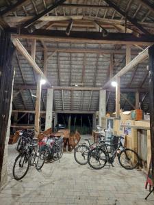a group of bikes parked in a warehouse at Pole Namiotowe Kogutowo in Wietrzychowice