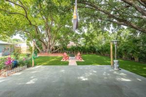 a backyard with a tree and a driveway at Beautiful House, Walking Distance to Stadium in Tampa