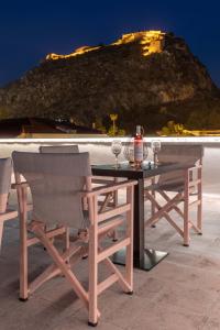a table and chairs with a view of a mountain at Eudokia Pension in Nafplio