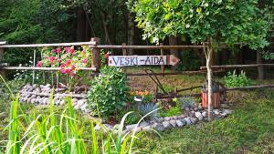 a garden with a street sign and some flowers at Veski Aida Holiday Home in Käina