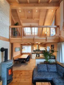 a living room with a couch and a stove at Alb Chalet in Meßstetten