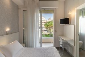 A bed or beds in a room at Hotel Majestic