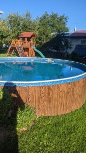 a swimming pool with a playground in a yard at Apartman692 in Vrchlabí