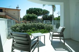 a patio with two chairs and a table on a balcony at Casa Francesca in Golfo Aranci