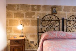 Postel nebo postele na pokoji v ubytování Baglio Spanò - Antiche Dimore di Sicilia