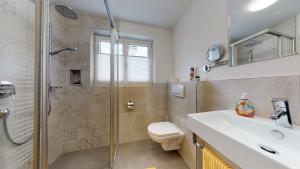 a bathroom with a shower and a toilet and a sink at FERIENWOHNUNGEN TANJA - dein Wohlfühlhaus in Kappl in Kappl
