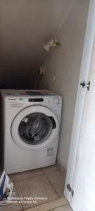 a washer and dryer in a corner of a room at Relaxing Country house Porto Vito in Aigosthena