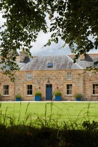 an old stone building with a blue door at Newhall Mains in Resolis