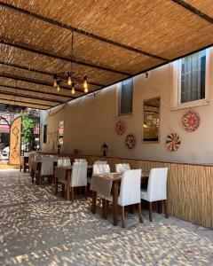 a dining room with a table and white chairs at MoY-Side in Side