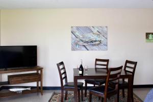 a dining room with a table and a tv at Surry Seafood Company in Surry