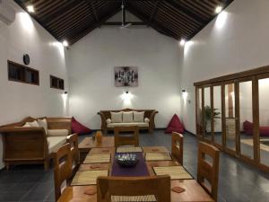 a living room with a table and some chairs at Villa Rosa East Bali in Karangasem