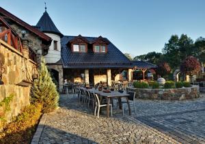 a table and chairs in front of a building at Zámeček Kaliště in Poddubí