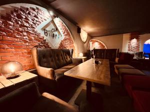 restauracja ze skórzanymi krzesłami i ceglaną ścianą w obiekcie ZAJAZD BIAŁCZAŃSKI Dom Wypoczynkowy Restauracja w mieście Białka Tatrzanska