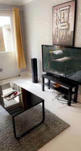 a living room with a television and a coffee table at SEMEC luxury apartment in Wainscot