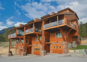 a large wooden building with balconies on it at The Residences at Fairmont Ridge in Fairmont Hot Springs