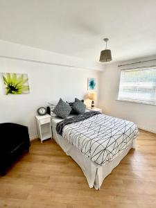 ein Schlafzimmer mit einem großen Bett in einem weißen Zimmer in der Unterkunft Chancellor Court Apartment in Liverpool