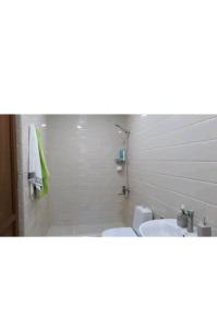 a bathroom with two sinks and a tub and two toilets at Geo Kutaisi in Kutaisi