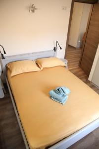 a bed with a towel sitting on top of it at Casa Domenica in Corfu Town