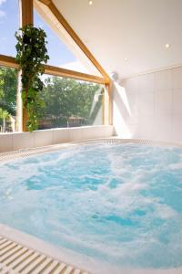 a large swimming pool with a large window at Sure Hotel by Best Western Ojaby Herrgard in Växjö