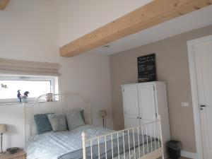 a bedroom with a white bed and a window at The Two Branches 