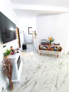 a living room with a marble floor and a table at Vila CASA HATERE in Moisei