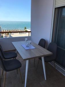 a table and chairs with a view of the ocean at Sea View Apartment Shkëmbi i Kavajes in Durrës
