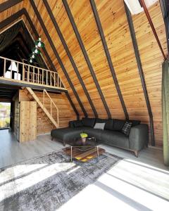 a living room with a couch and a wooden ceiling at KARYA BUNGALOV VİLLA in Dalaman