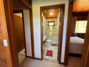 a bathroom with a shower and a toilet in a room at Rancho Nosso Lago in Domingos Martins