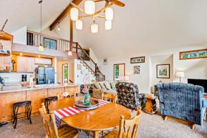 a kitchen and living room with a table and chairs at Garfield Bay View Home in Sagle