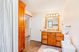 a bathroom with a sink and a mirror at Garfield Bay View Home in Sagle +20 photos