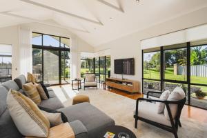 a living room with a couch and a tv at The Lodge - Dunsborough in Dunsborough