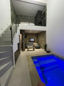 a house with a swimming pool in a living room at Stone Suites in Pefkohori