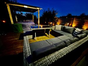 a couch and a table on a patio at night at Sleeps 10-12 Snowdonia North Wales Nr Zip World in Tanygrisiau