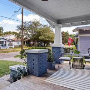 a patio with a table and chairs on a porch at Family Vacation Home in Tampa, Florida in Tampa