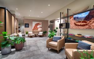 un soggiorno con sedie, tavoli e piante di Gravity Haus Moab a Moab