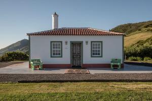 a small white house with a red roof at Casita - Cantinho do Paraíso in Vila do Porto