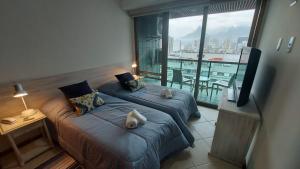 Una habitación de hotel con dos camas y una gran ventana. en TIFFANYs RIO FLAT, en Río de Janeiro 114 fotos más