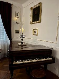 a piano sitting in a room with candles on it at City-Apartment S in Graz